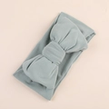 Detailed close-up of a soft milk silk baby headband featuring a large olive green bow - Bean Green