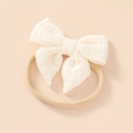 Soft creamy white cotton gauze baby headband with a flexible nylon bow band - Beige