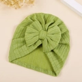 Close-up of baby turban hat with knit texture and large bow in soft light green - M / Light Green