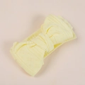 Macro detail of breathable knit texture and large bow on yellow baby headband - 15.5x8.5cm / Yellow