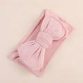 Detail of soft milk silk fabric texture on a large pink baby bow headband for infants - Light Pink