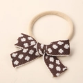 Close-up detail of soft elastic nylon headband with a brown knitted bow for newborn infants - 9x6cm / Dark Brown White Floral