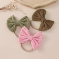 Three-pack of soft nylon baby headbands with textured jacquard knit bows in earth tones - 11x9cm / Random Color