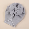Close-up of grey knitted baby hat showing the warm fleece lining and large bow detail - One Size / Gray