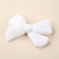 Close-up of white knitted bow hair clip showing dense warp-knitted mesh texture - 9*6CM / White