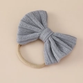 Detail of soft grey knitted bow on elastic beige nylon headband for infants and babies - 11x9cm / Dark Gray