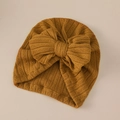 Detail of mustard yellow ribbed knit baby turban hat with a large decorative bow - Ginger Yellow