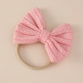 Close-up of pink jacquard knit bow headband with soft stretch nylon elastic band - 11x9cm / Peach Pink