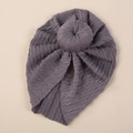 Detail of grey cable knit baby turban hat showing soft texture and donut knot - Dark Gray