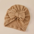 Close-up of ribbed texture and oversized bow on khaki baby turban winter hat - Camel