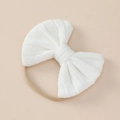 Detailed macro view of white textured knit bow baby headband with elastic nylon band - 11x9cm / White