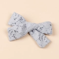 Close-up of light blue hollow lace bow hair clip with vintage embroidery texture - 10x8cm / Light Blue