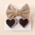 Detail view of baby bow headband and heart-shaped sunglasses on a display card - Light Coffee