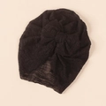 Detailed macro view of the intricate lace mesh texture and bow design on the black turban - Black