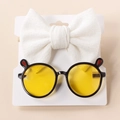 Detail of white waffle knit bow headband and round sunglasses with cute red ear accents - Black Edge Yellow