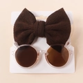 Detail of pink bear-ear sunglasses and brown knit bow headband on white card - Transparent Dark Coffee