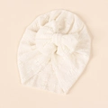 Detail view of cream baby turban with a large soft bow and delicate textured knit fabric - Off White