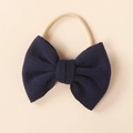 Detail showing dark blue knitted bow headband with soft ribbed texture and elastic nylon band - Navy Blue (#13)
