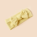 Close-up of soft ribbed knit texture and large bow on this light yellow infant headband - Pale Yellow Style (#13)