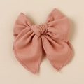 Detailed view of linen fabric bow hair clip with textured dusty rose weave and raw edges - Dusty Rose