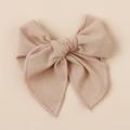 Close-up of handmade linen bow hair clip showing premium texture and stitching details - Beige