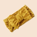 Gros plan d'un bandeau bébé en maille jaune avec nœud texturé et motif jacquard - Jaune Gingembre / 17*8.5cm