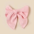 Close-up of pink linen-blend bow hair clip with textured fabric and detailed edge stitching - Pink