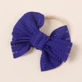 Detail of baby headband featuring dark blue hollow lace bow and nude elastic nylon band - 11x10cm / Dark Blue