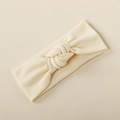 Detail of soft ribbed knit cream baby headband with stylish twist knot design - Off White