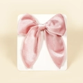 Close-up of pink velvet bow hair clip with neat stitching on white display card - 13cmx12.5cm / Pink