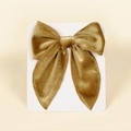 Detail of a golden velvet swallowtail bow hair clip on a white display card backing - 13cmx12.5cm / Army Green