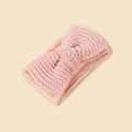 Close-up of pink knitted baby headband featuring a large bow and soft textured knit - Pink