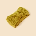 Detailed close-up of mustard yellow knitted baby headband with a chunky bow texture - Yellow