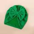 Detailed view of emerald green waffle texture baby turban hat with a large bow detail - 17*18.5cm / Green