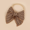 Detail of tweed bow headband showing intricate black and gold woven fabric texture - 10.5*10.5cm / Caramel color