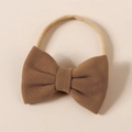 Close-up of a brown cashmere-like bow headwrap with a soft beige elastic nylon hairband - 8.5*6cm / Camel