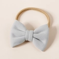 Close-up of a soft light blue cashmere-like bow on a stretchy nude nylon baby headband - 8.5*6cm / Light Gray