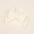 Macro detail of soft knit cream infant turban hat with a large 3D decorative bow - 17.5*18cm / Beige