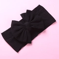 Diadema elástica negra de tela acanalada para bebés con un lazo grande con textura - Negro