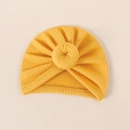 Close-up of yellow ribbed knit baby hat featuring a round donut-style bow detail - 18*17cm / Ginger Yellow