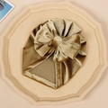 Detail of baby velvet turban hat in champagne gold with a large bow decoration - Army Green