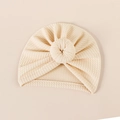 Close-up of cream waffle-knit baby turban hat with a stylish donut knot detail - 18*17cm / Beige