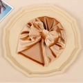 Detailed texture of baby velvet turban hat with oversized bow in caramel gold color - Orange