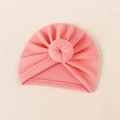 Detail view of pink ribbed knit baby turban featuring a soft donut knot design - 18*17cm / Watermelon red