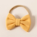 Detail of soft yellow faux cashmere bow on a nude stretch nylon infant headband - 8.5*6cm / Yellow