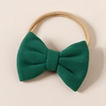 Close-up of dark green faux cashmere bow on a soft nude nylon headband for infants - 8.5*6cm / Green