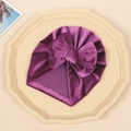 Detailed texture of purple velvet baby beanie featuring a large elegant bow knot - Rose Red