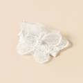 Detail of white embroidered lace butterfly hair clip with a center pearl on apricot background - Pearl Butterfly Style (#2)