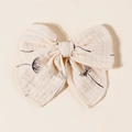 Detailed close-up of muslin fabric bow hair clip with black dandelion floral print - 11.5x10cm / Beige Black Dandelion (#10)