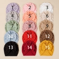 Flat lay display of 15 colorful stretch knit baby beanies with bow details in 3x5 matrix - 17.5x17 cm / Random Color